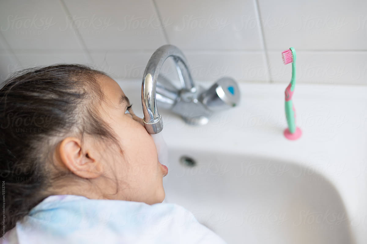 Girl Brushing Teeth In Bathroom