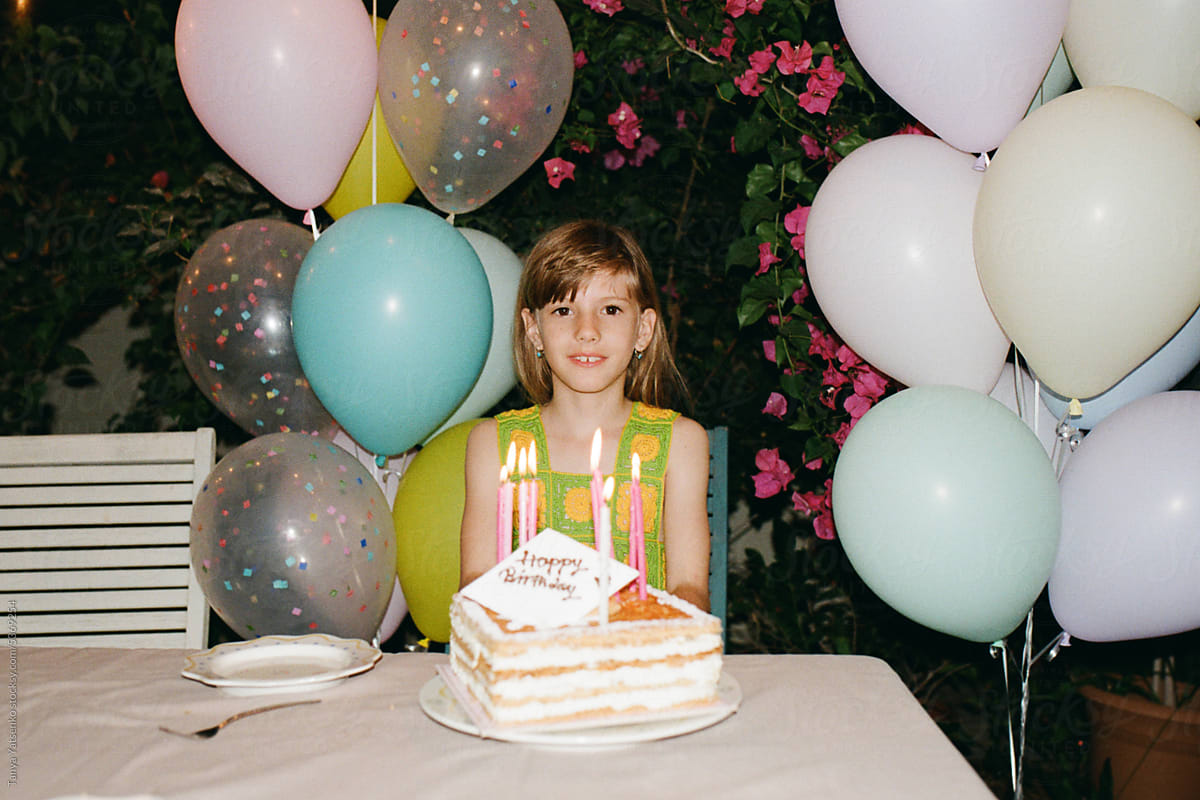 Girl with a birthday cake in the garden