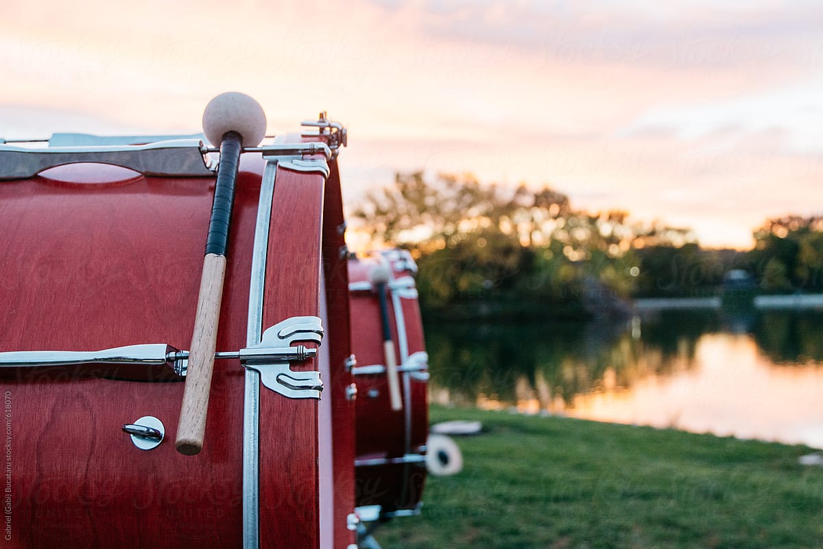 Marching band drums in a park at sunset