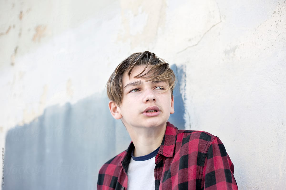 Male teenager by a wall