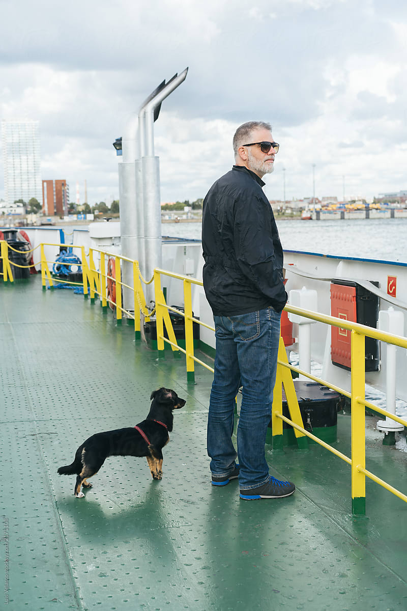 A Man With A Dog On A Boat.
