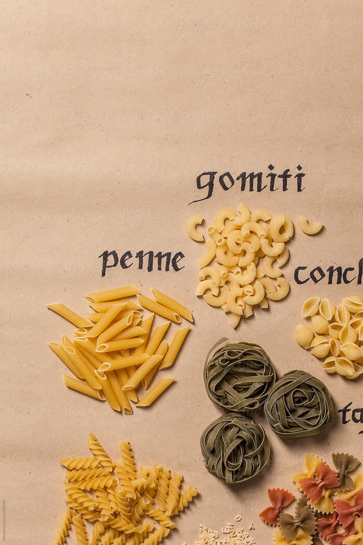 Various pasta on a paper background.