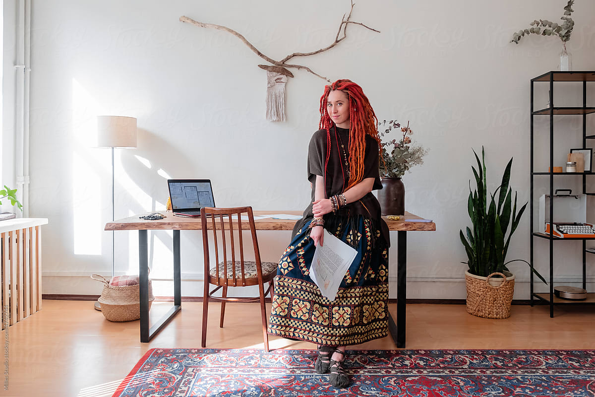 Female architect leaning on desk in home office