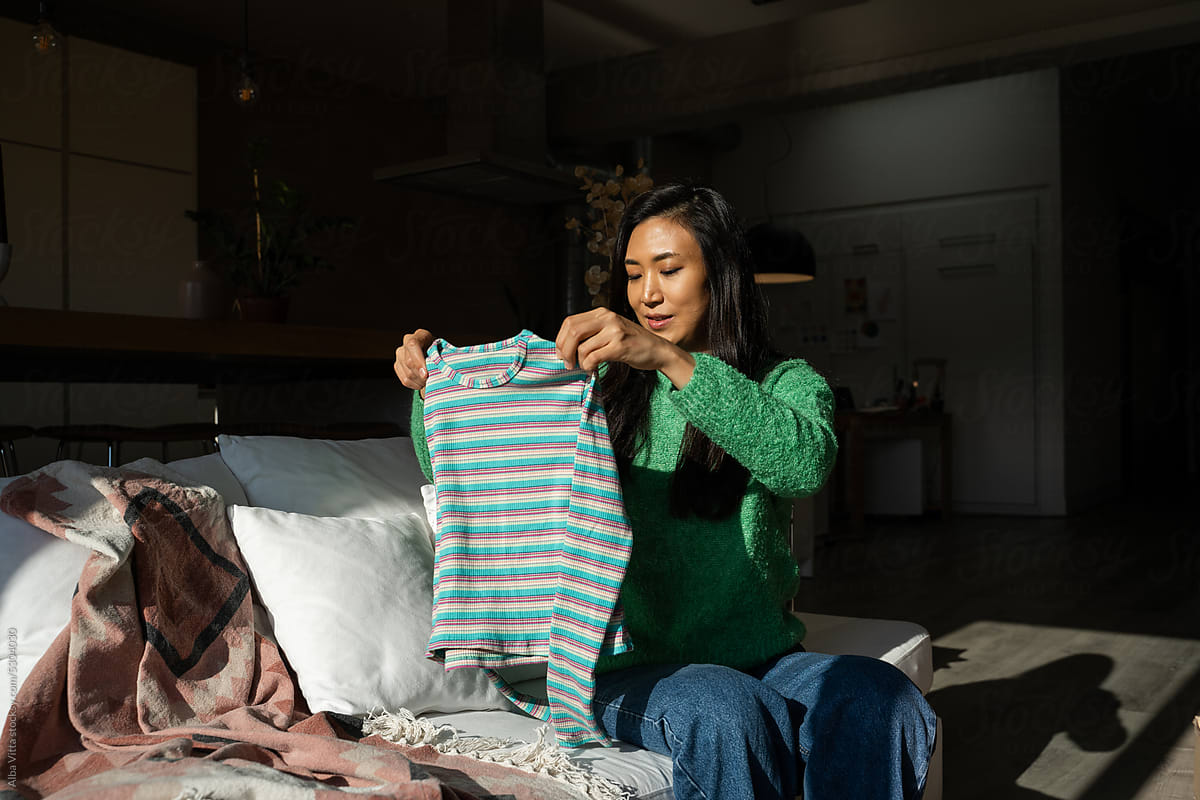 Woman Folding Laundry at Home