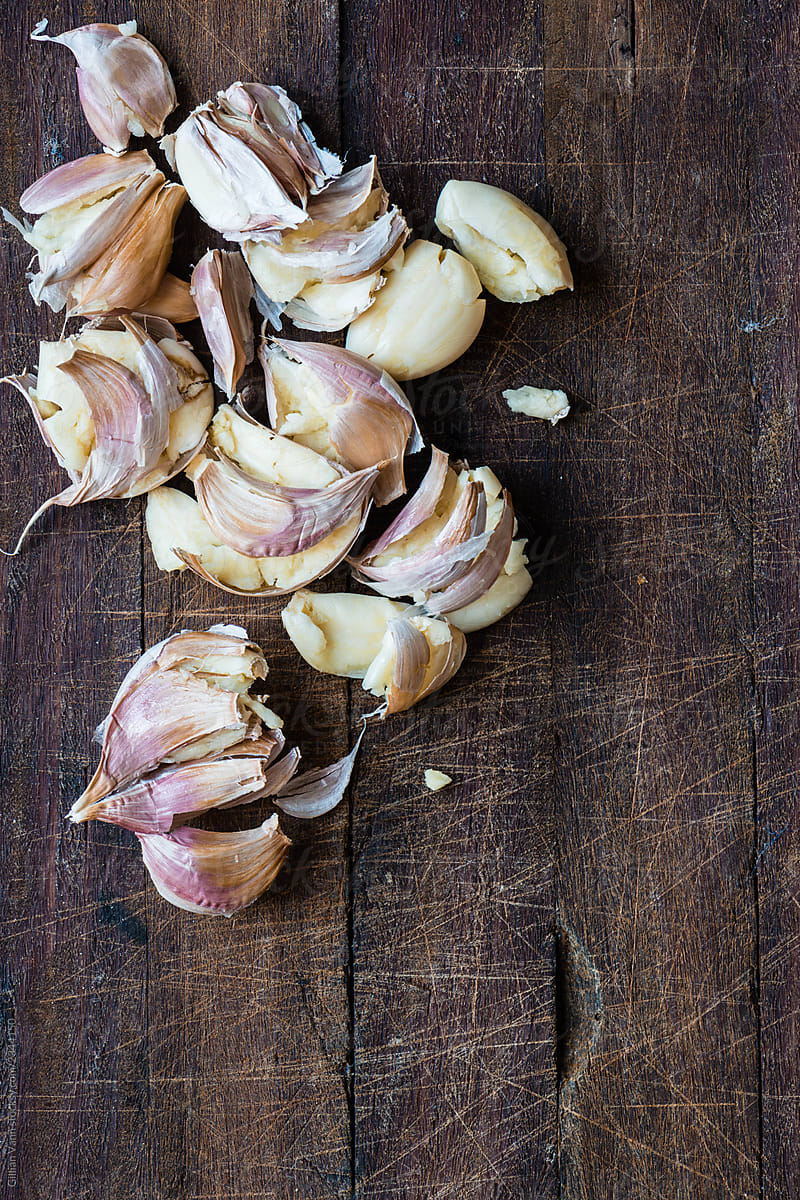 smashed garlic on a wooden board, with copyspace