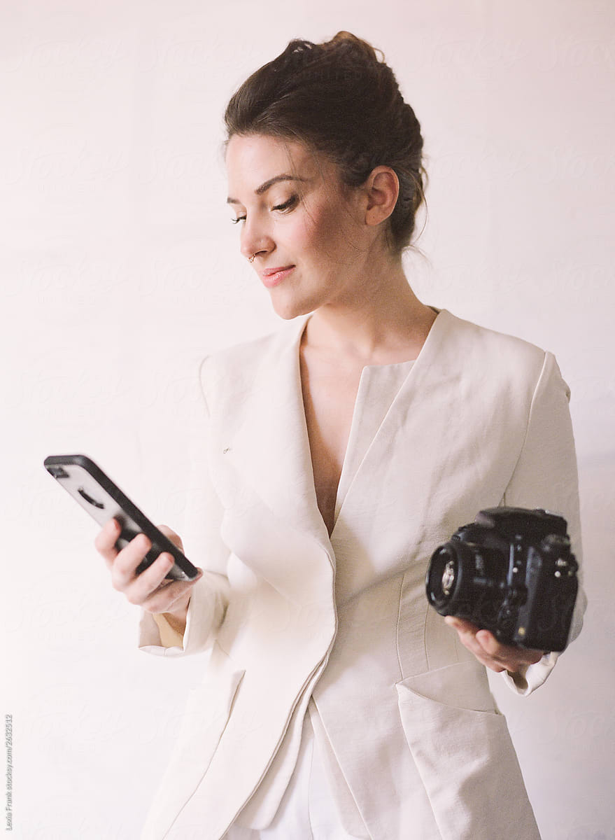 professional woman holds camera