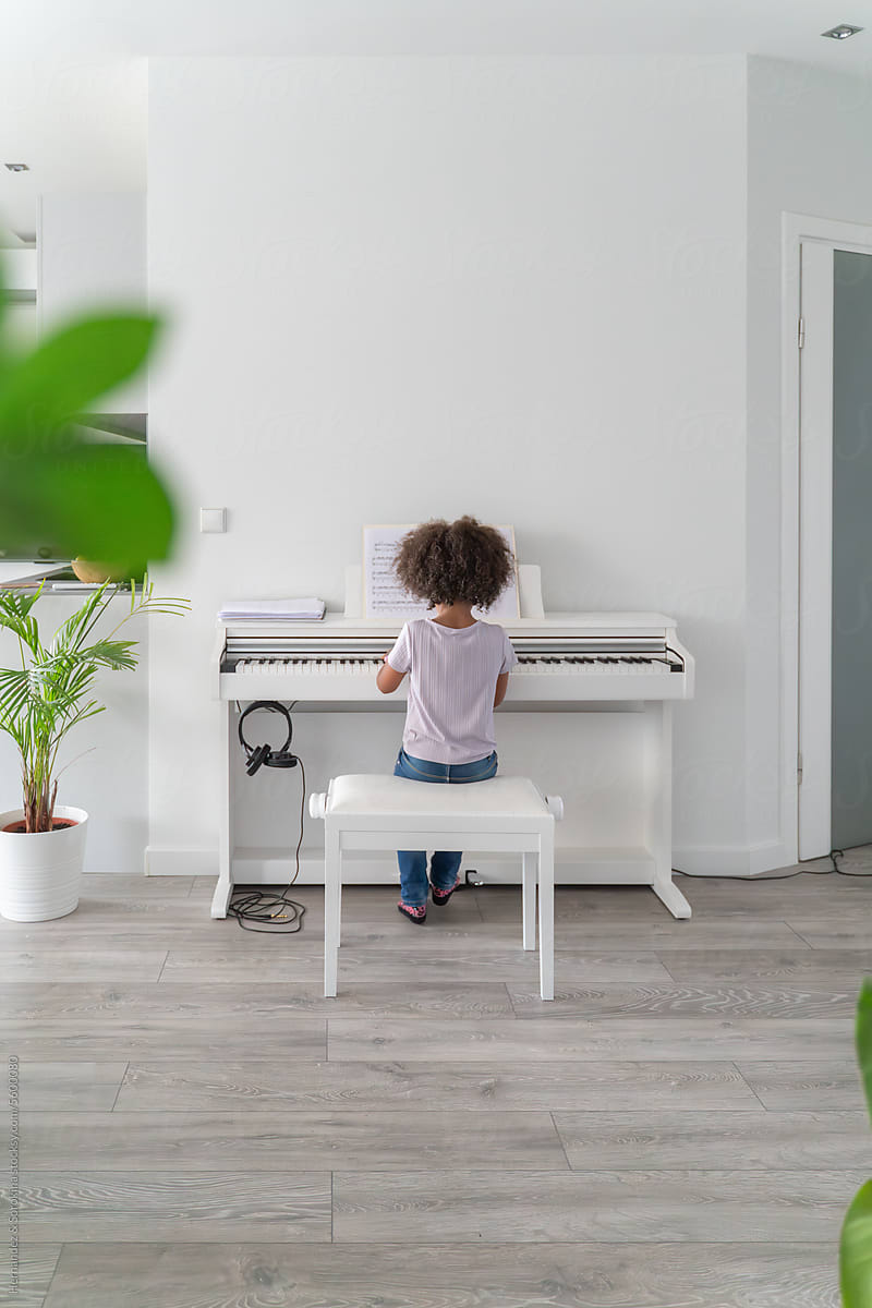 Anonymous Girl Is Playing The Piano At Home