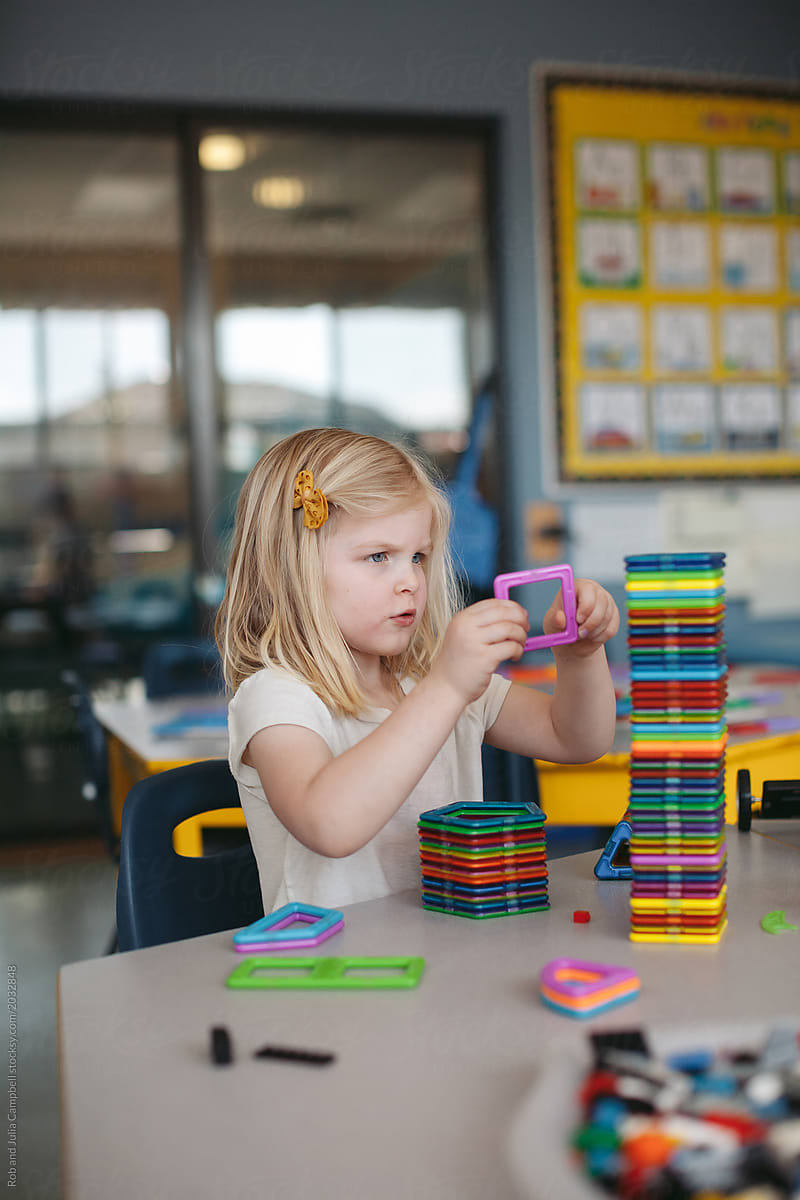 Young person playing with building toys