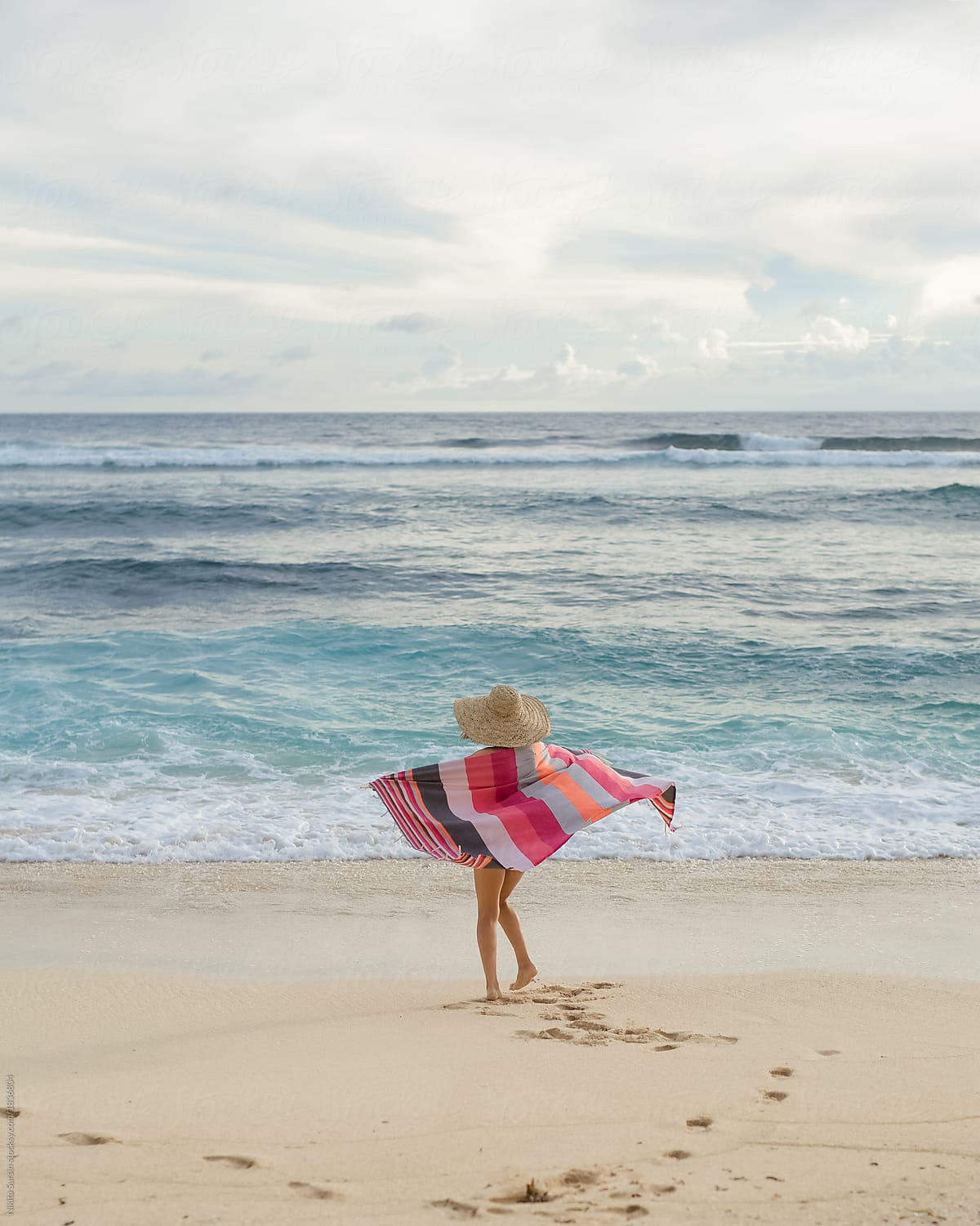 Back View: Woman In Swimwear Walk On The Beach by Nikita Sursin
