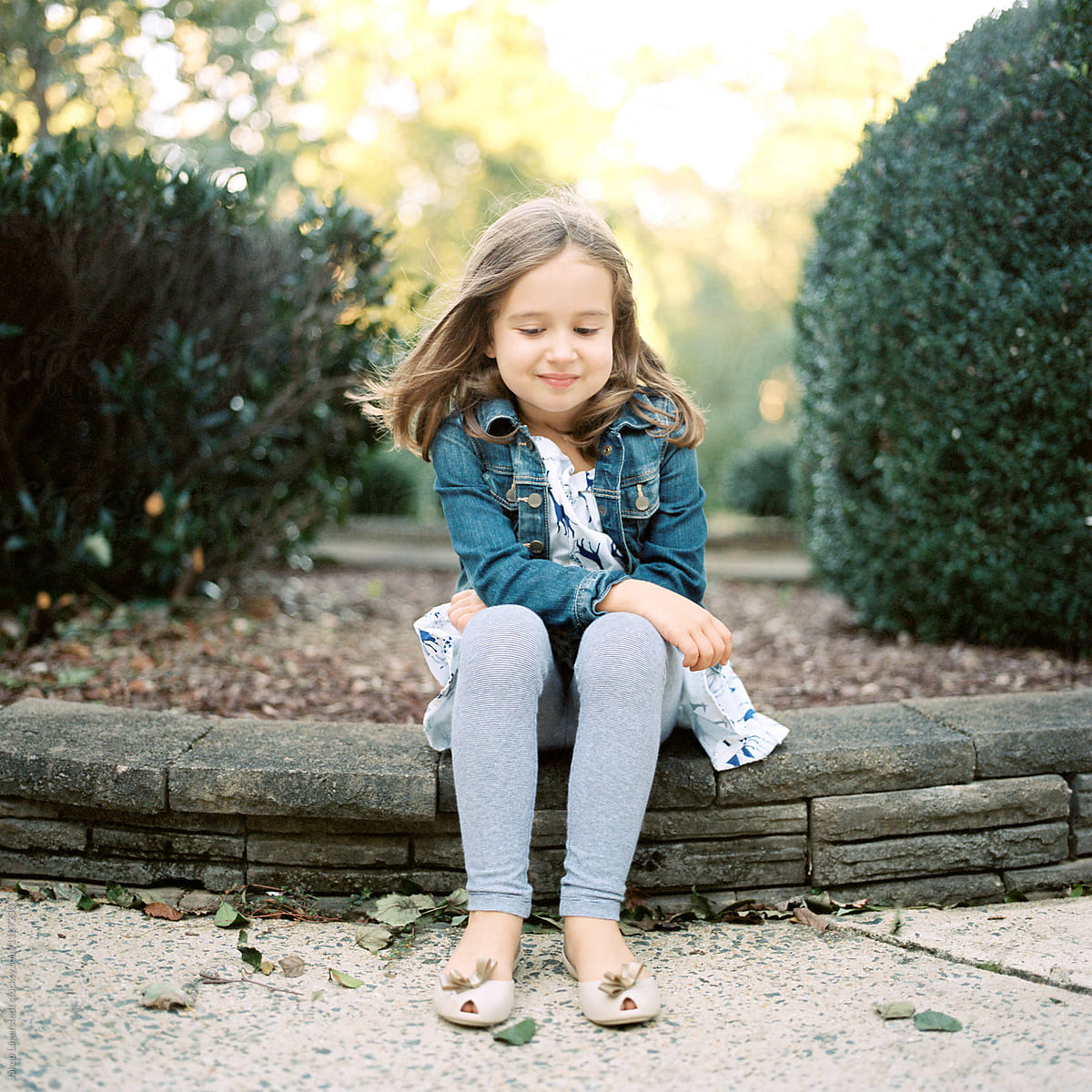 Cute Young Girl Sitting On Stone Wall By Stocksy Contributor Jakob Lagerstedt Stocksy 