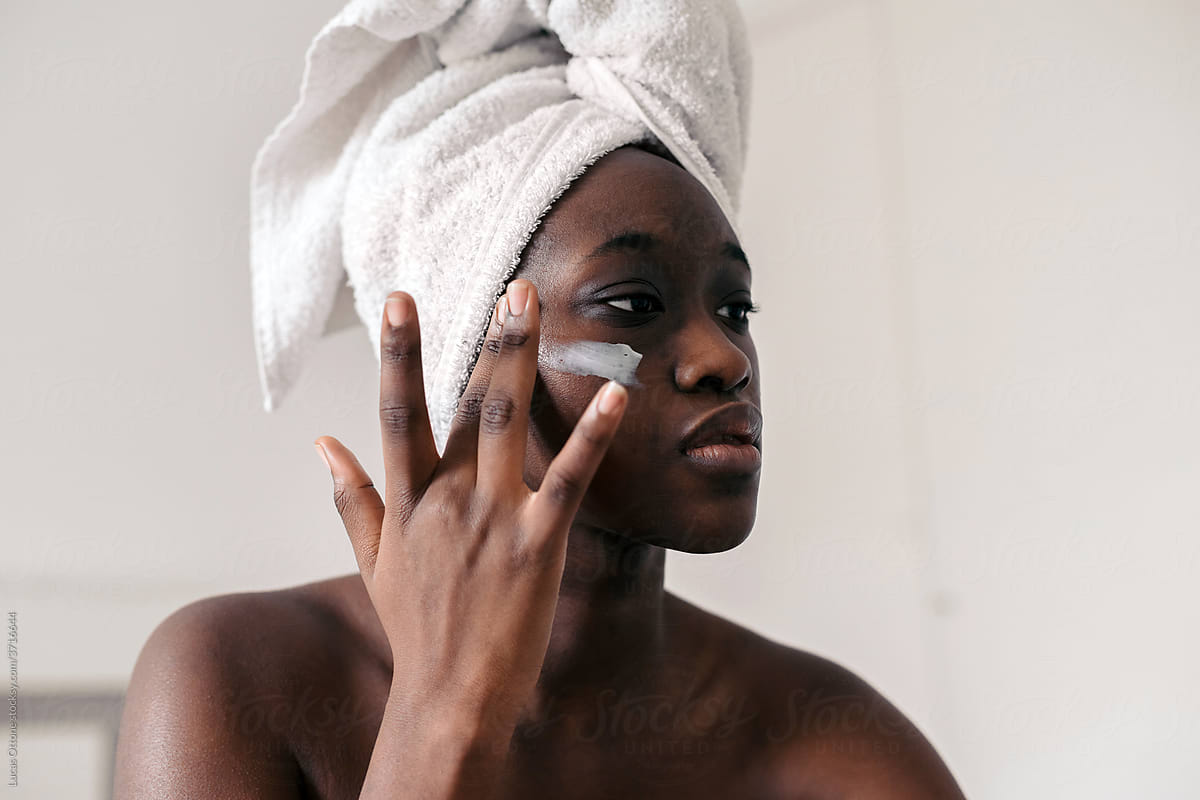 Black woman using lotion