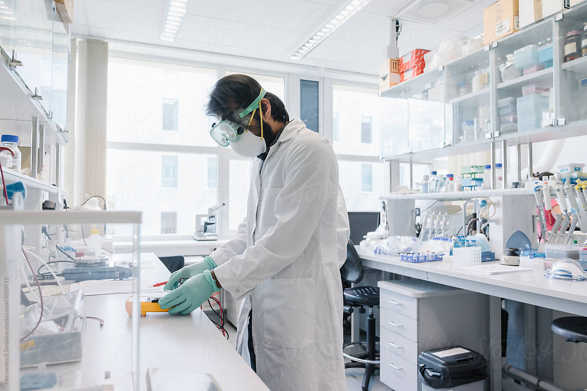 Researcher Wearing Protections Working At Laboratory