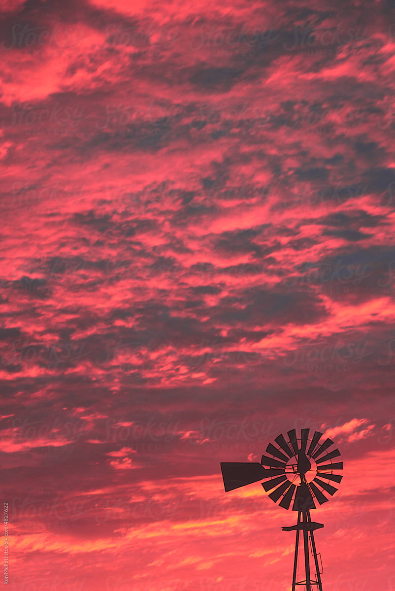 windmill silhouetted sunset red sky prairies Saskatchewan Canada film