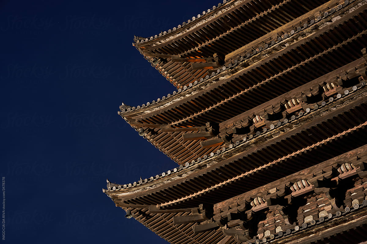 Traditional oriental pagoda in garden against night sky