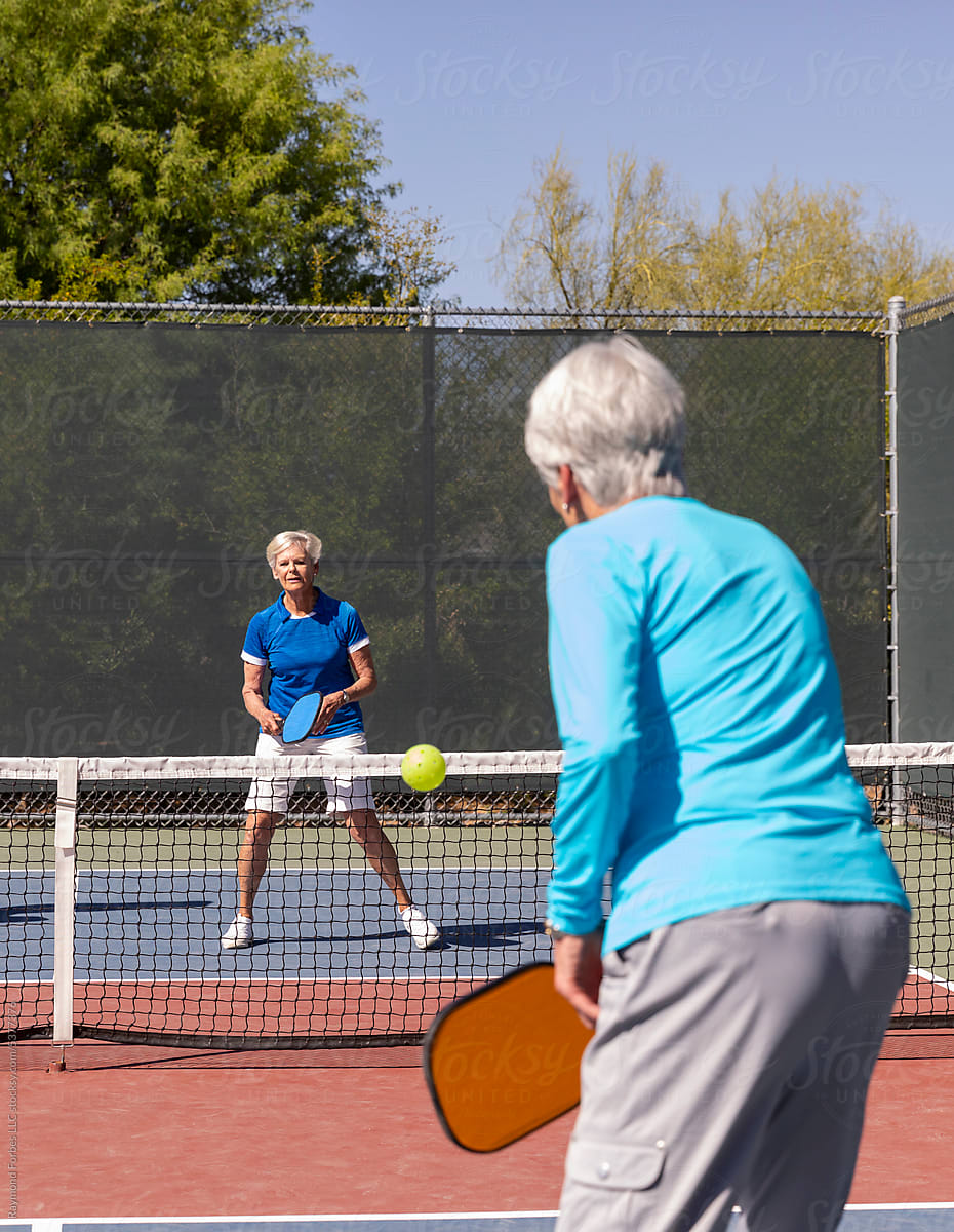 Senior Citizens playing match on Pickleball court
