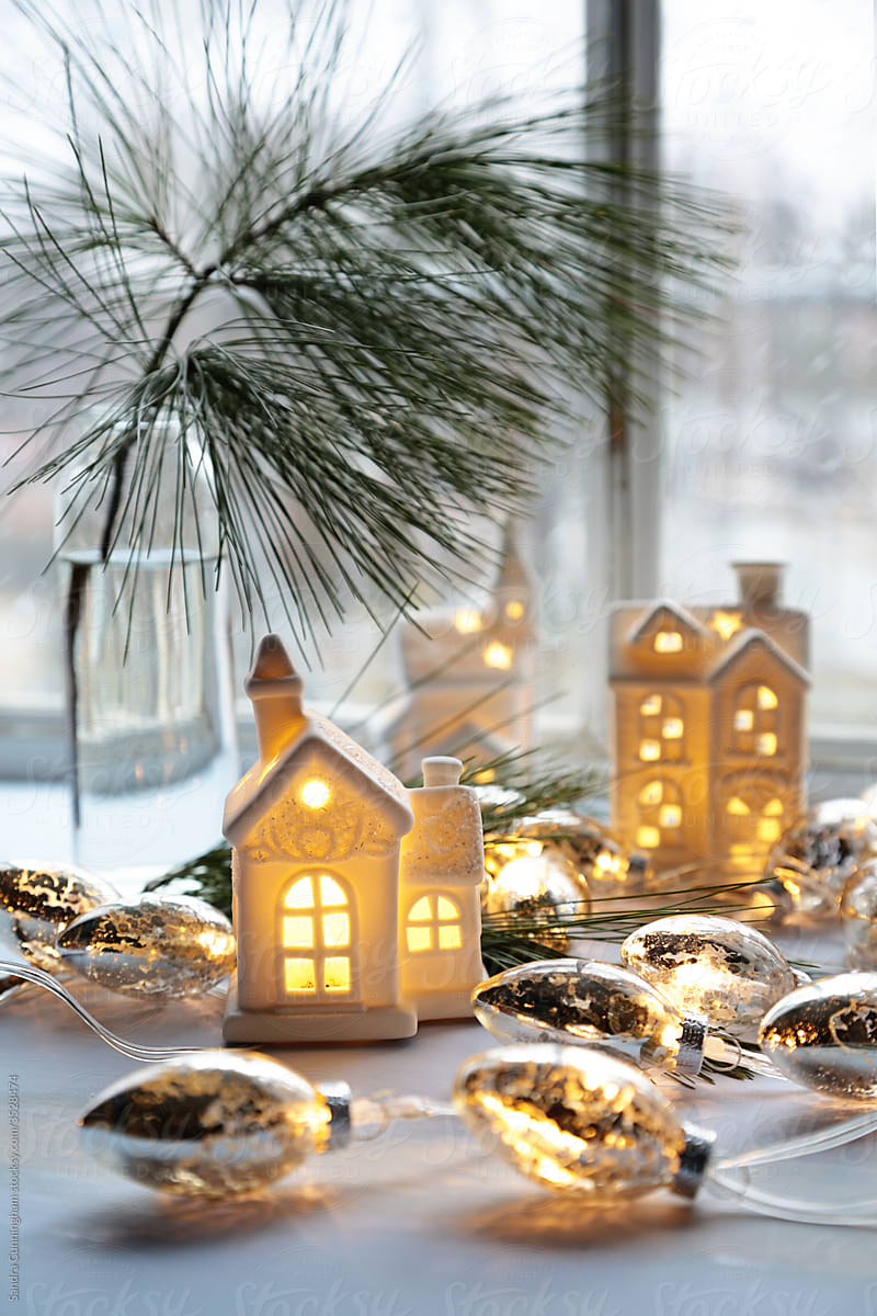 Little white  houses with gold lights near window