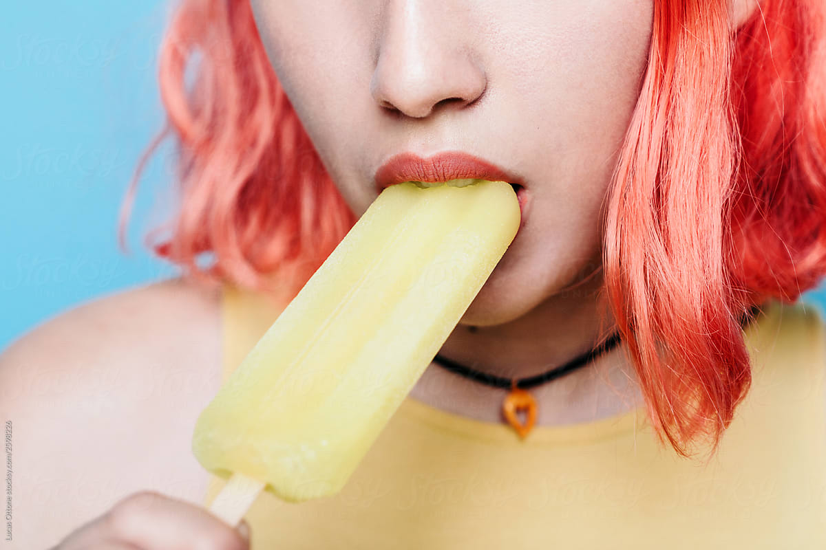Young woman with lemon ice lolly