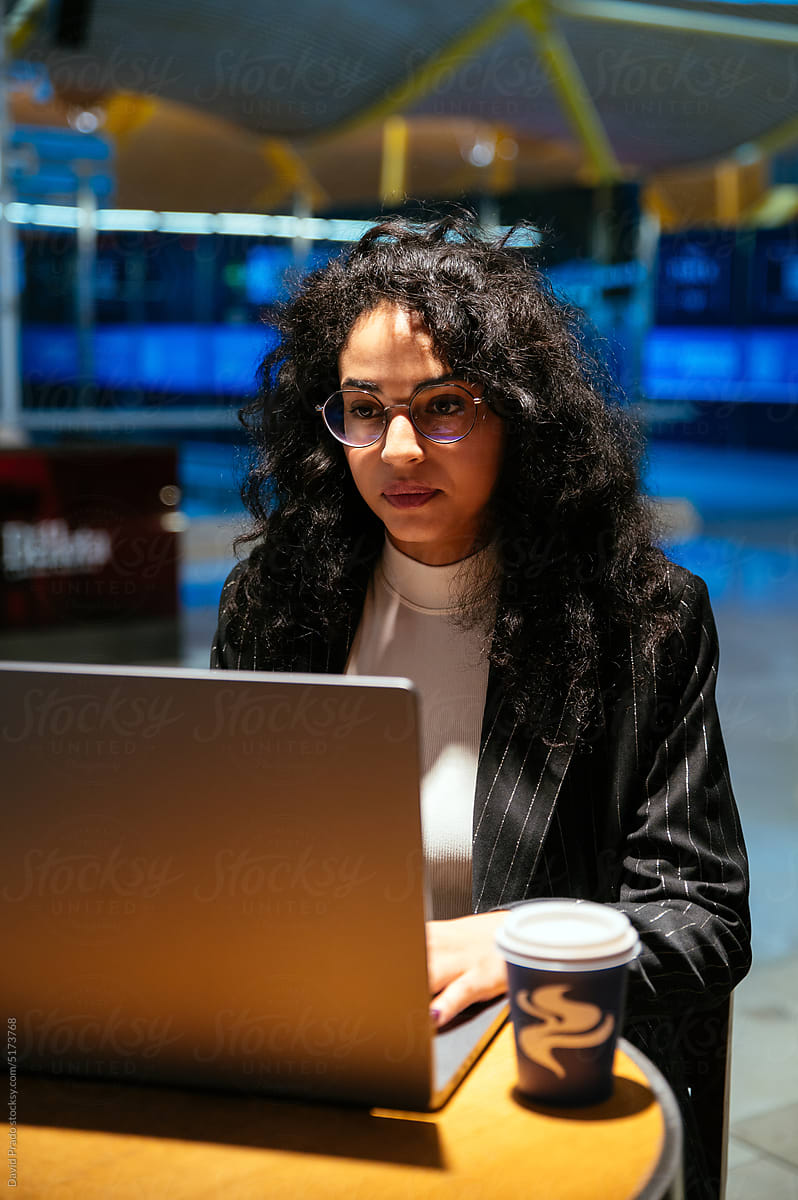 Businesswoman using netbook in modern airport