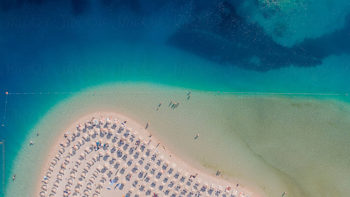 aerial photo of a sandy beach with clean azure water, paradise resort