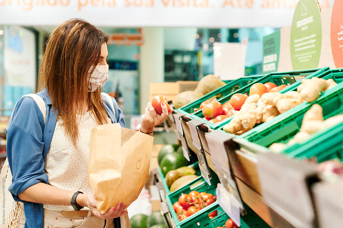 Woman in a face mask shopping in a grocery store