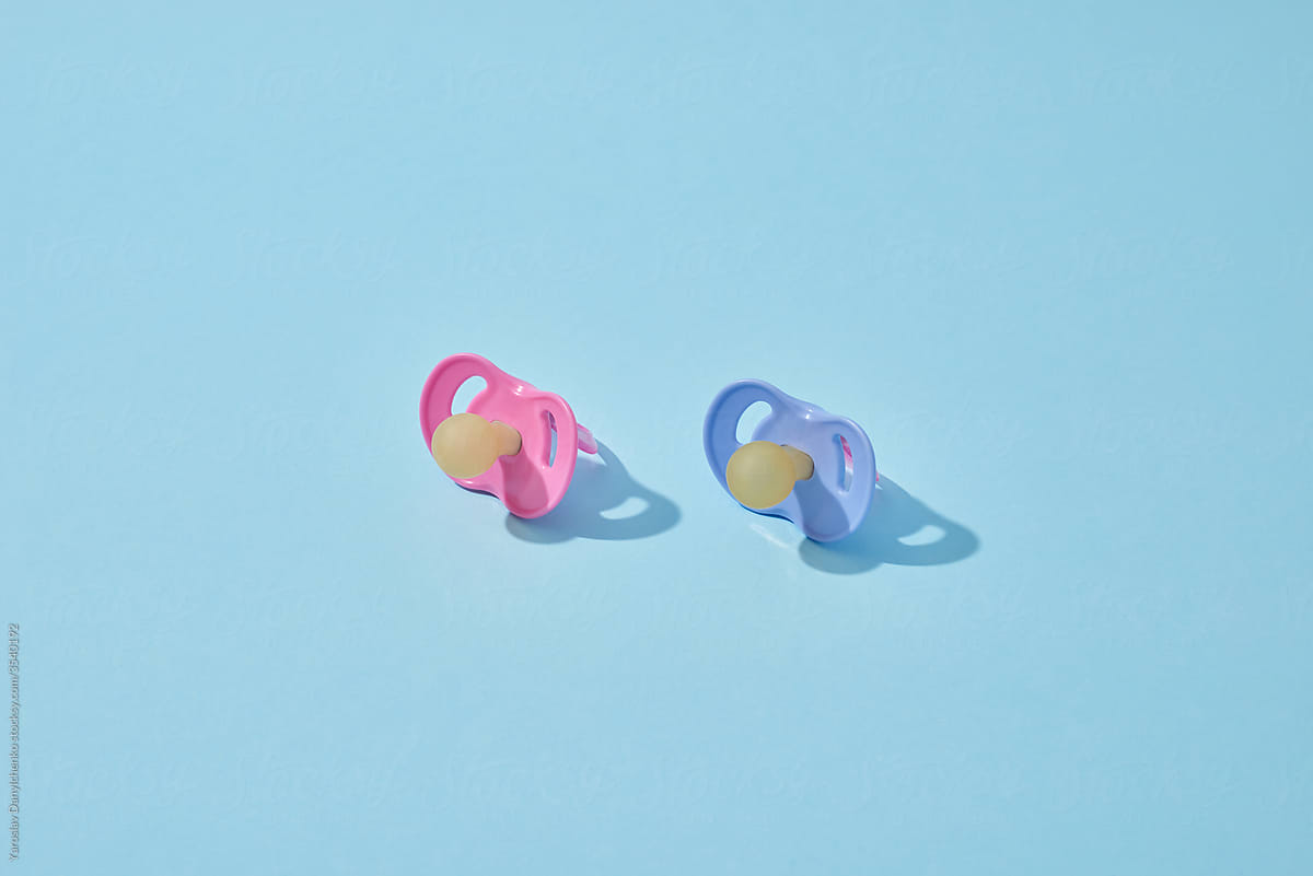 Blue and pink orthodontic baby pacifiers.