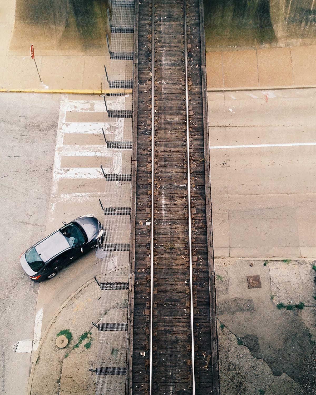 Car Driving Under Raised Train Track