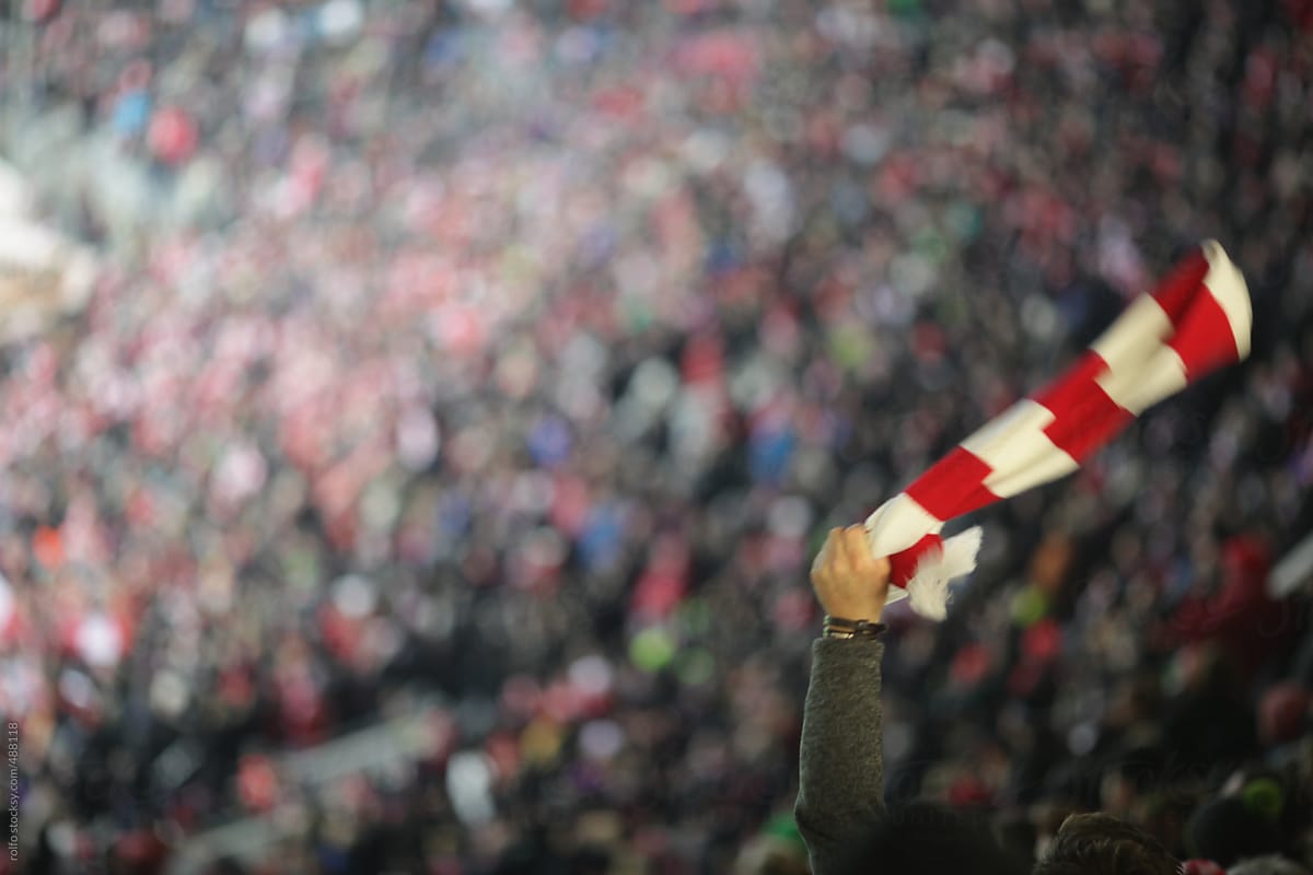 soccer stadium fan hand red white scarf