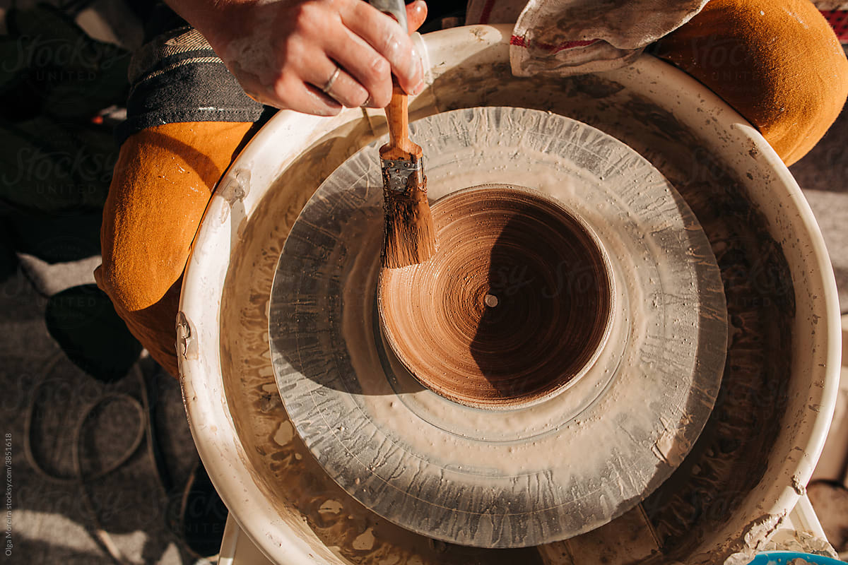 Female hands working on a pottery wheel