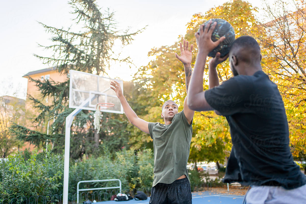 A Couple Of Black Men Playing Basketball.