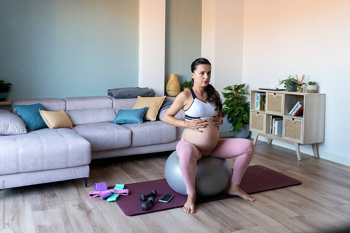 Pregnant Woman Sitting On Birthing Ball
