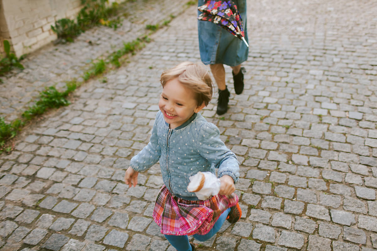 Little girl running with ice-cream