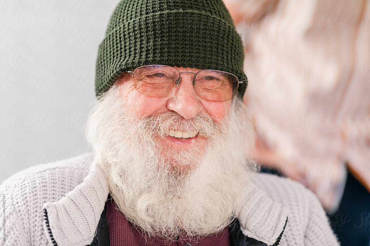 Smiling graybeard man in winter clothes