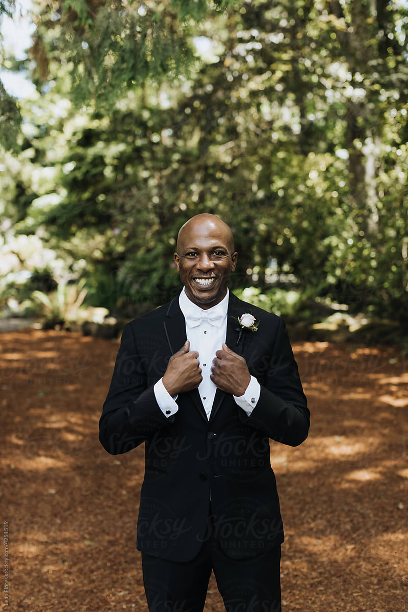 A Smiling Groom Adjust his Tuxedo and Smiles