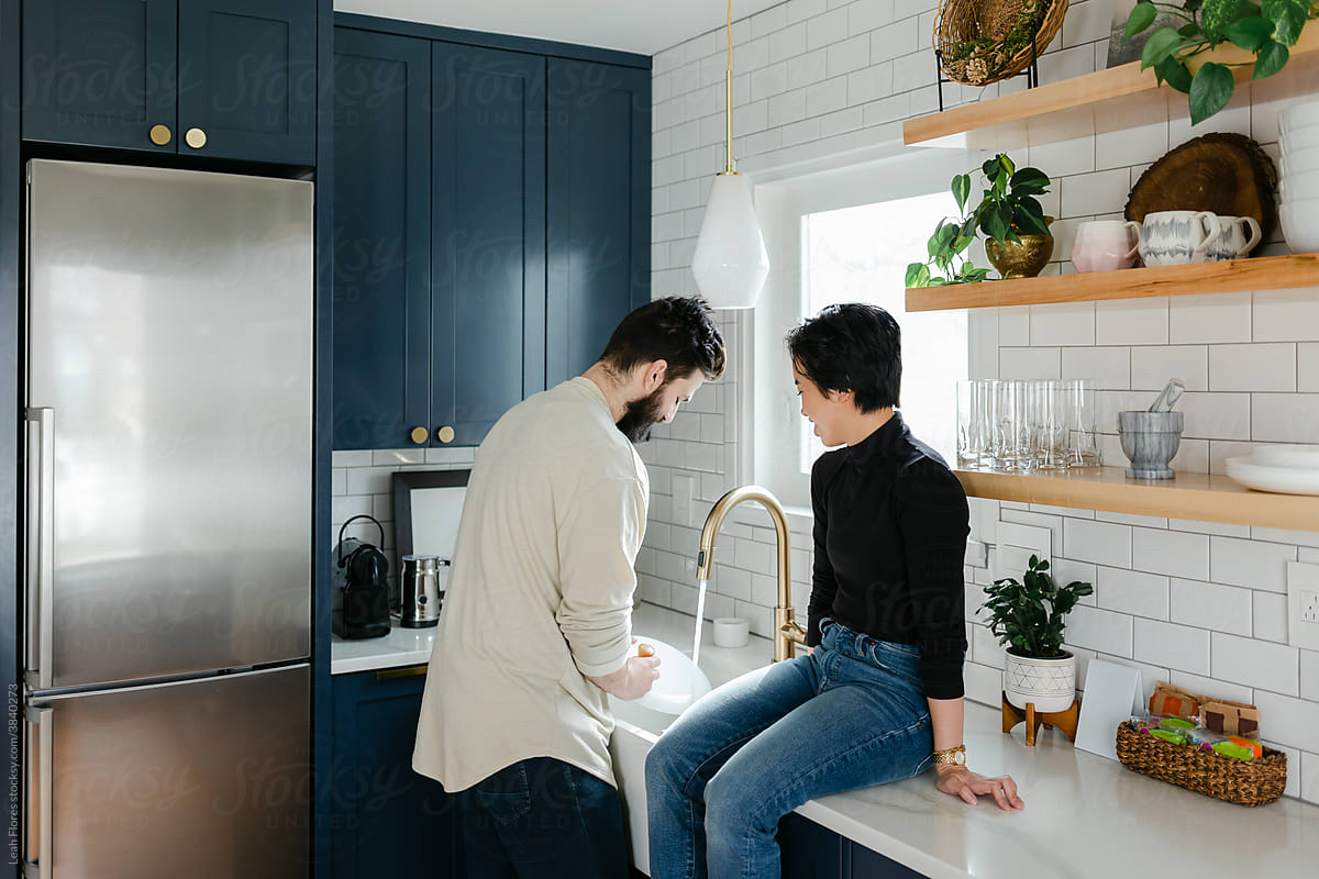 Couple Washing Dishes Together in Kitchen
