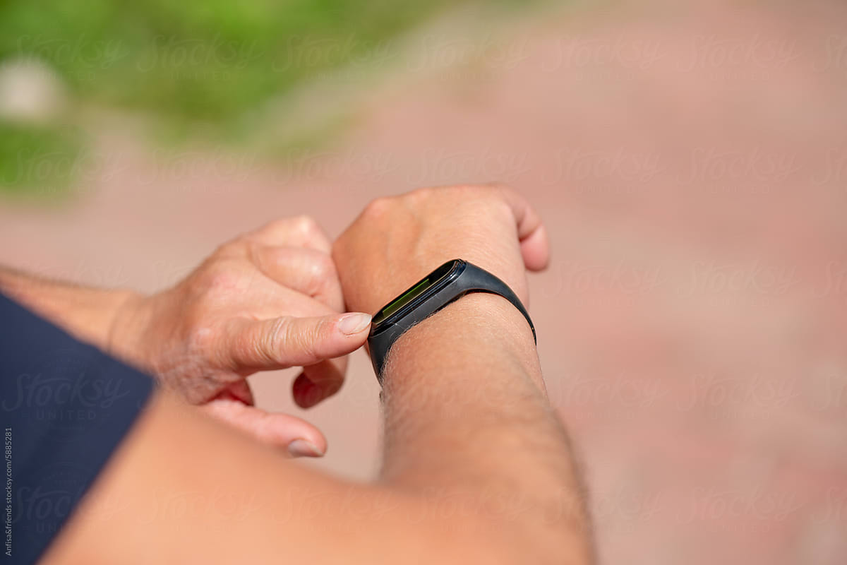 Checking Fitness Tracker During Outdoor Exercise