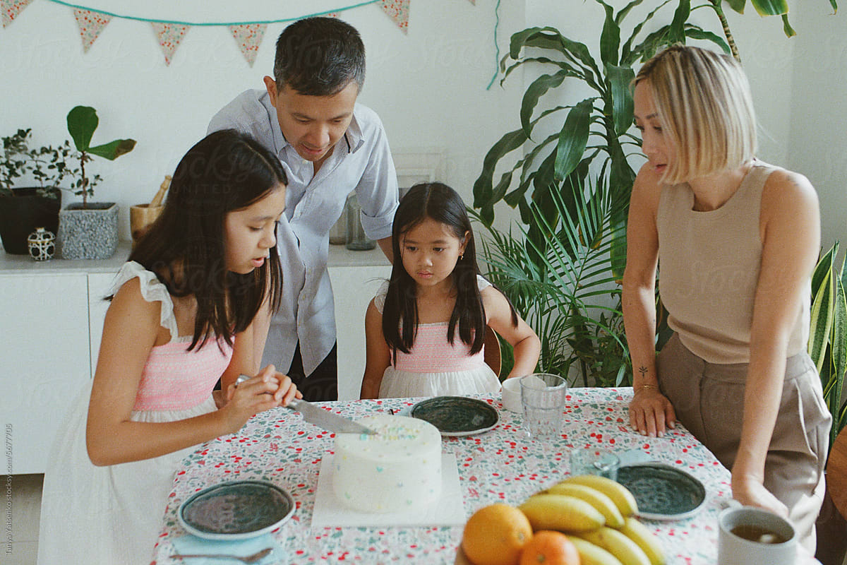 Family cutting a  birthday cake