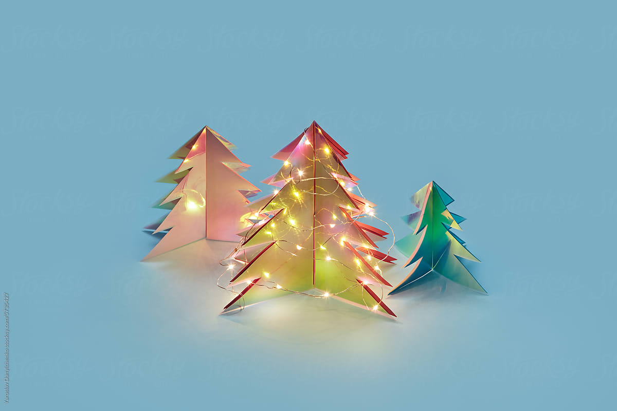 Christmas trees from holographic plastic shining with garlands