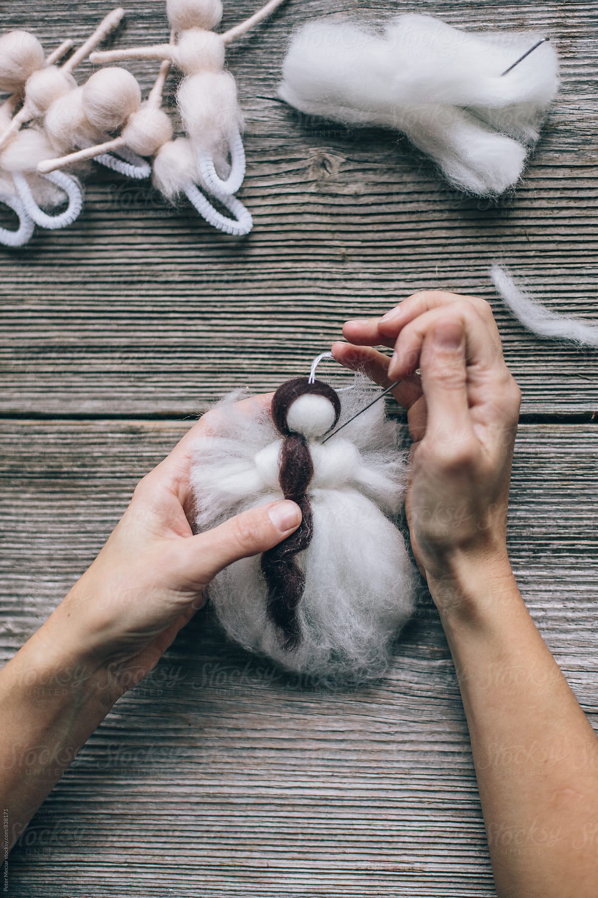Handmade production of an angel made of merino wool