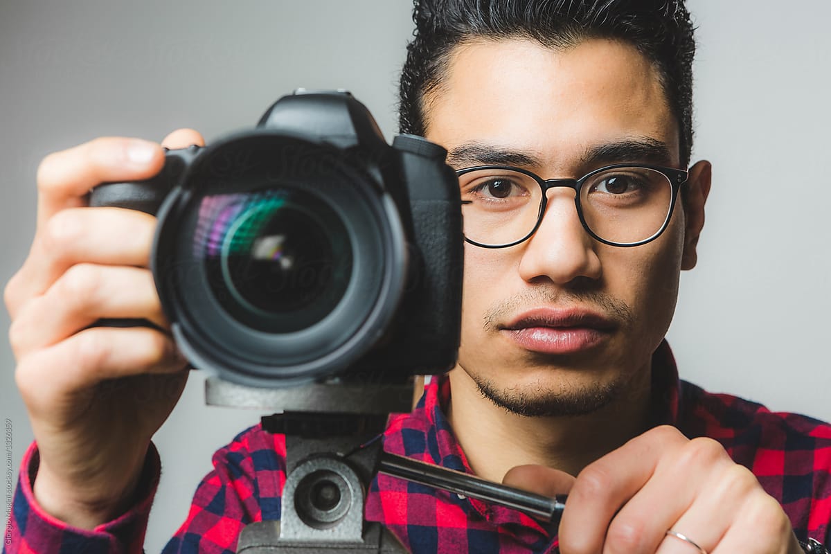 Young Man Portrait with a Digital Reflex Camera on a Tripod
