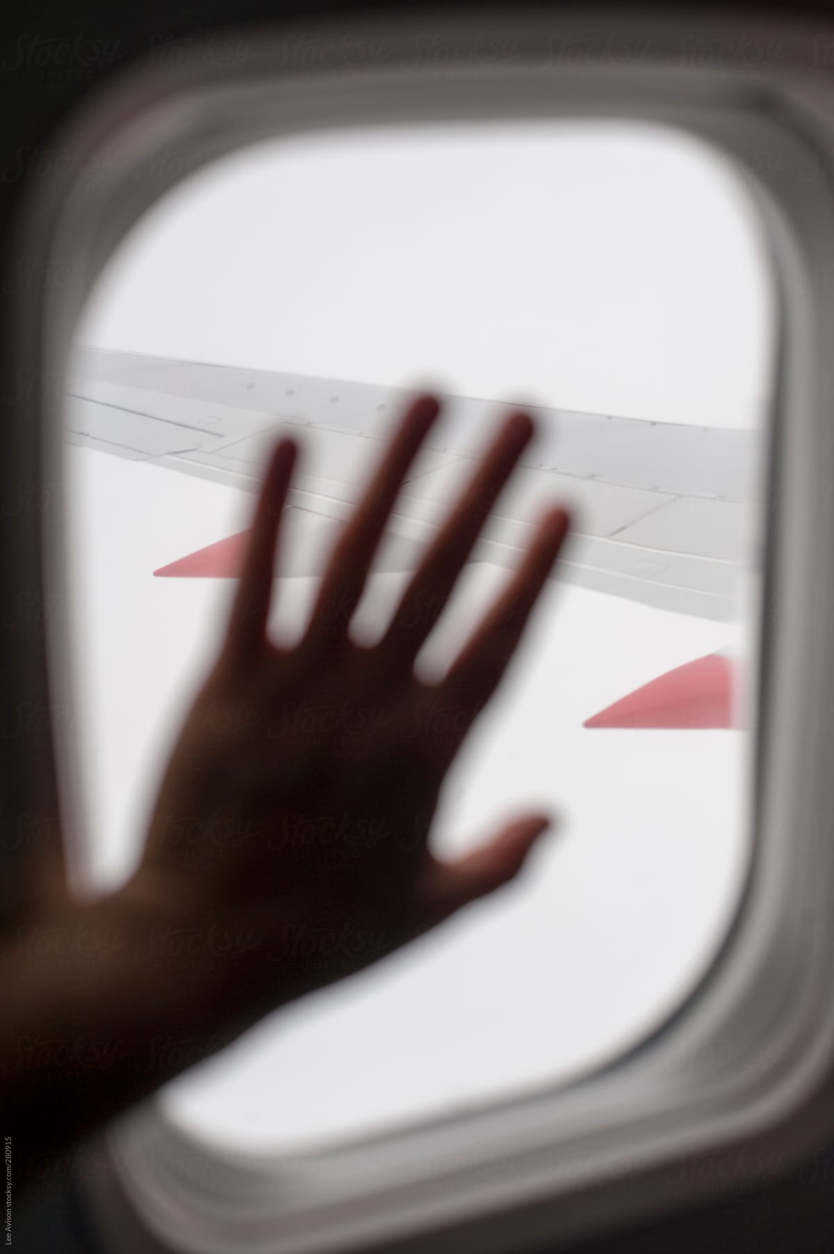 hand on an aeroplane window