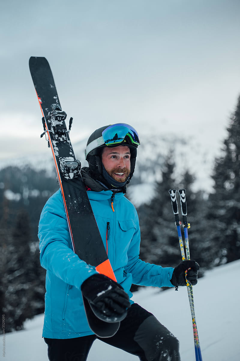 Skier carrying skis