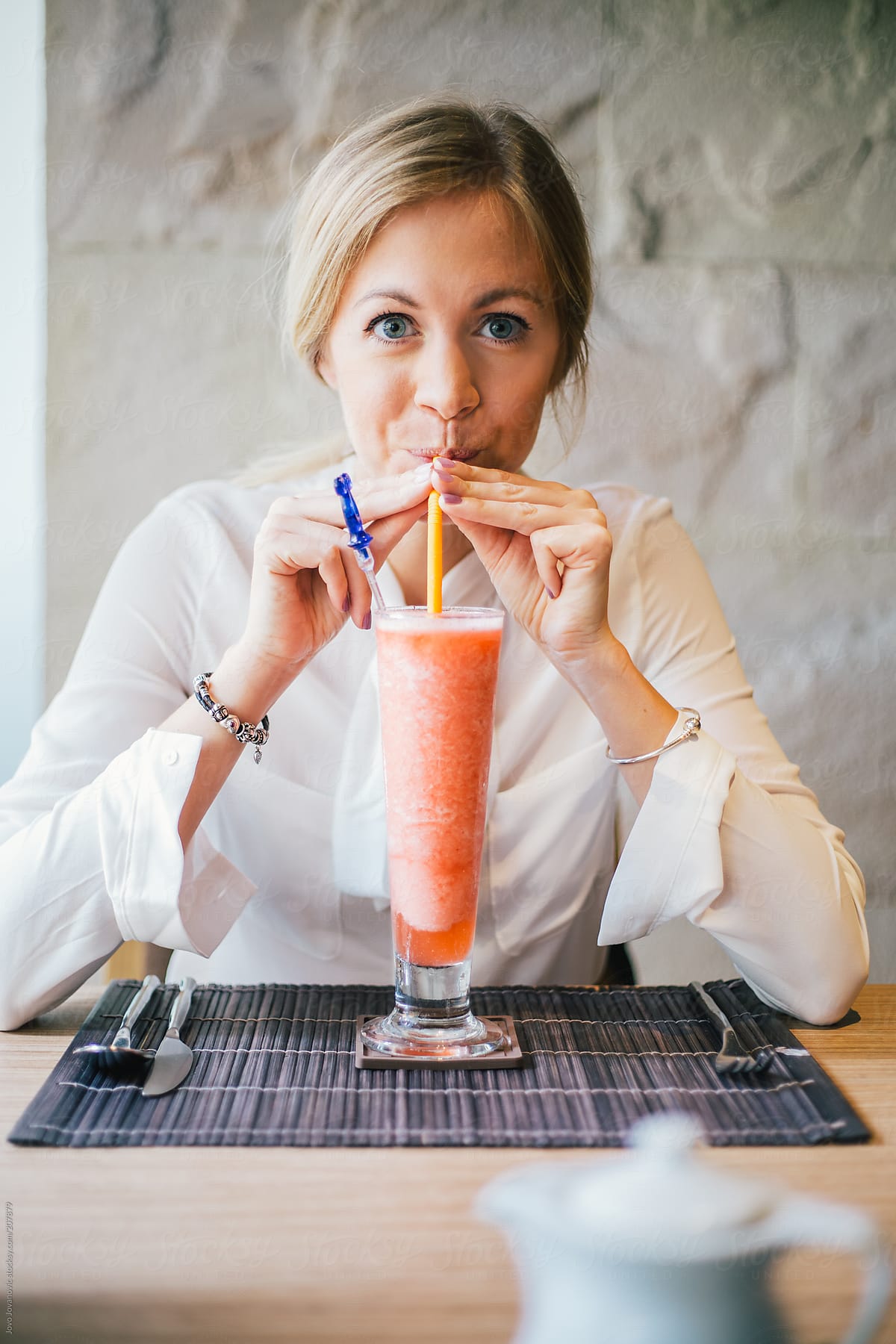Cute Blonde Girl Drinking Smoothie In A Restaurant By Stocksy Contributor Jovo Jovanovic 