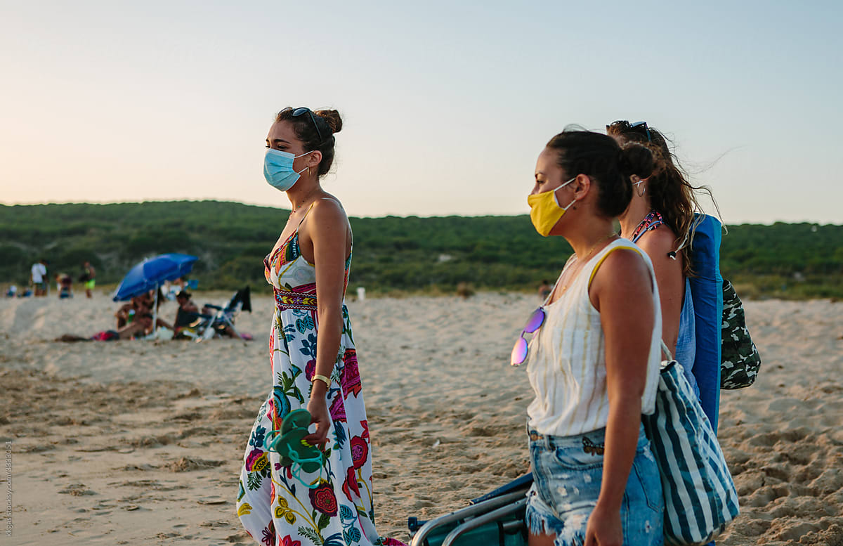 Chatting with masks on at the beach