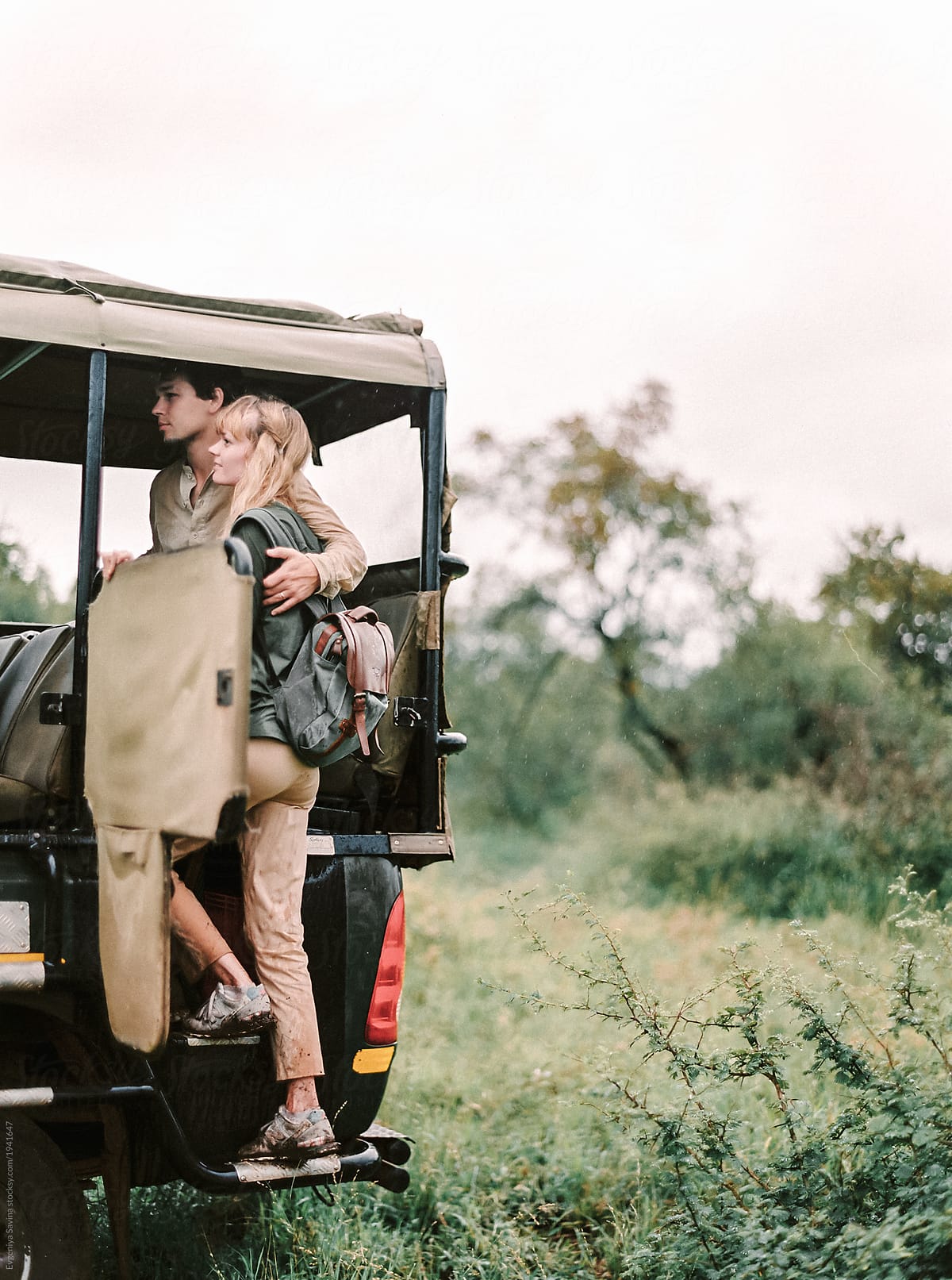 A couple on their honeymoon doing a walking safari and trying to spot a game