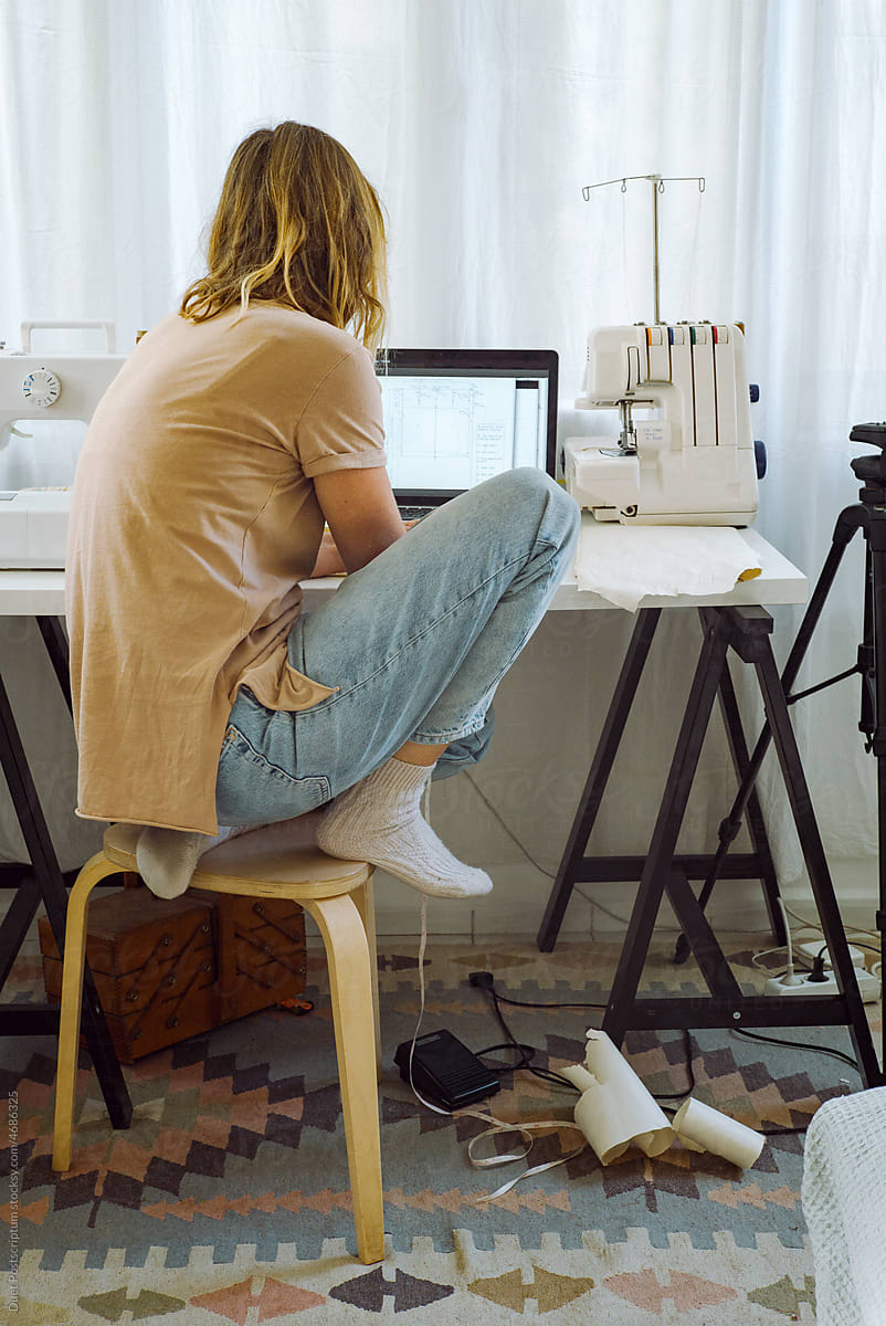 A tailor on her workplace in home studio.