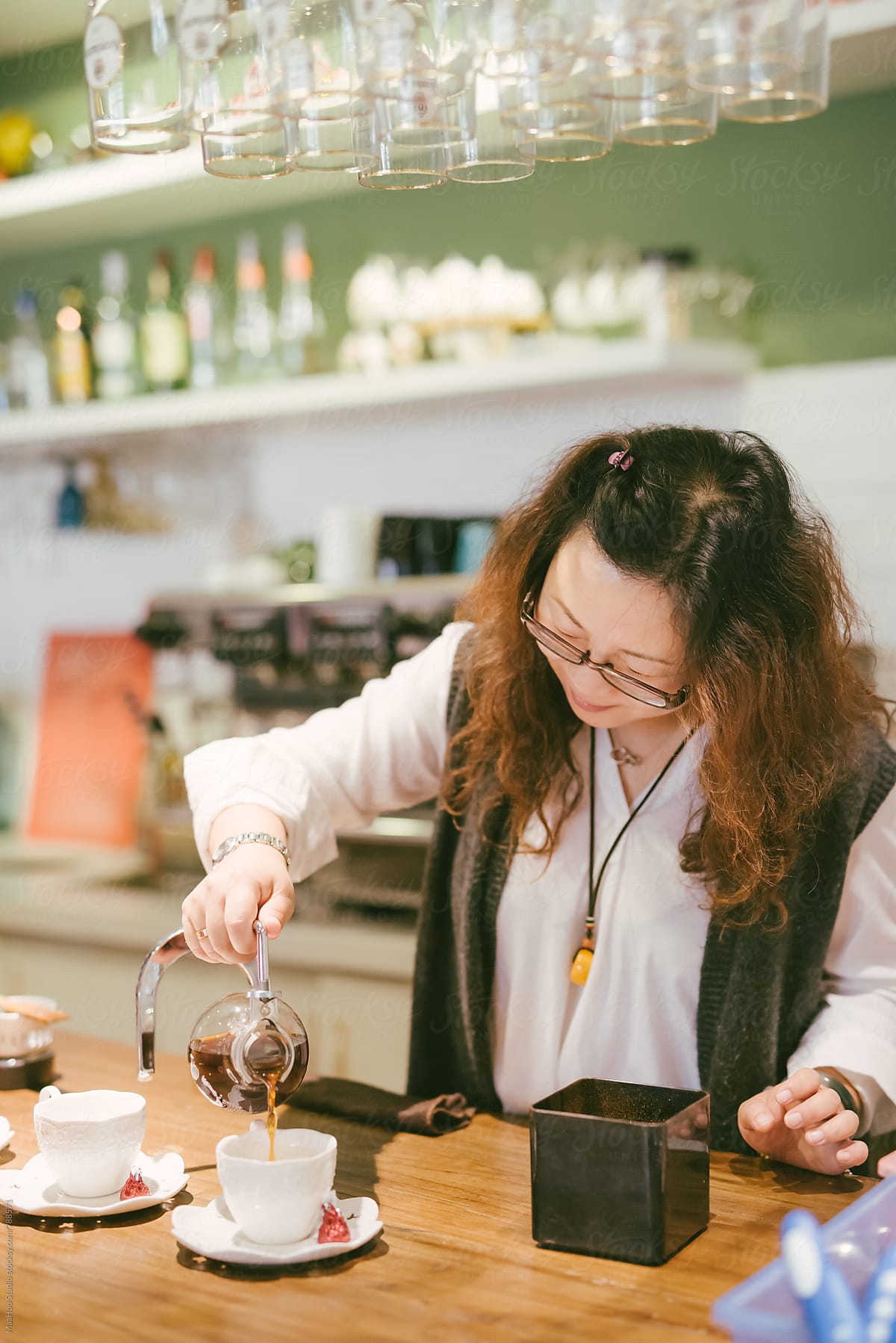 Female coffee shop owner preparing coffee at counter