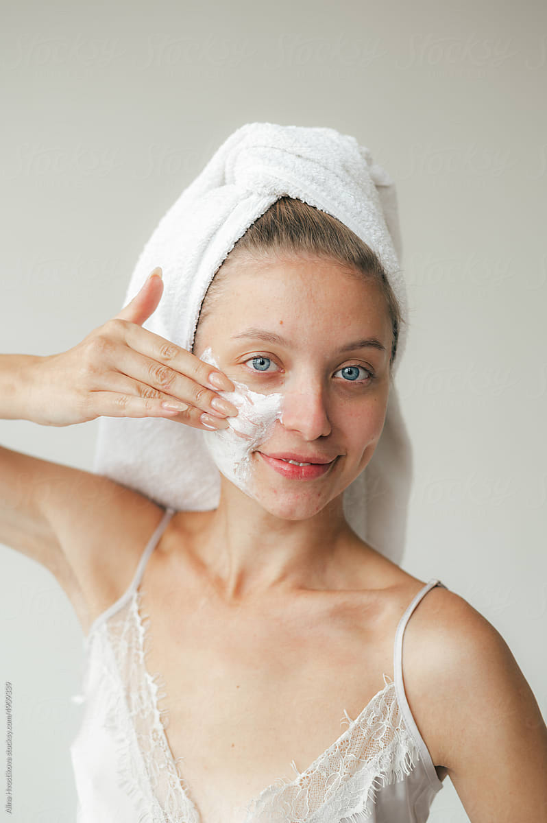 Lady applying facial cleanser during morning routine
