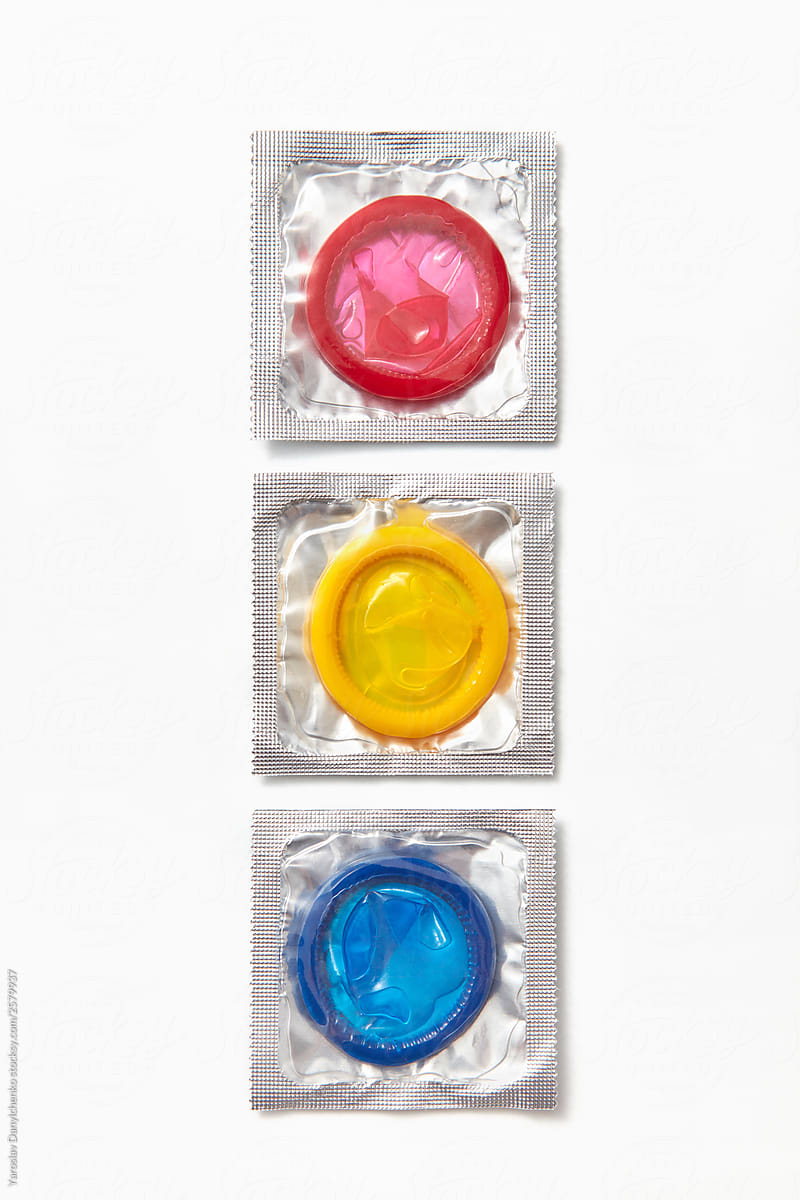 Three colored condoms packs.