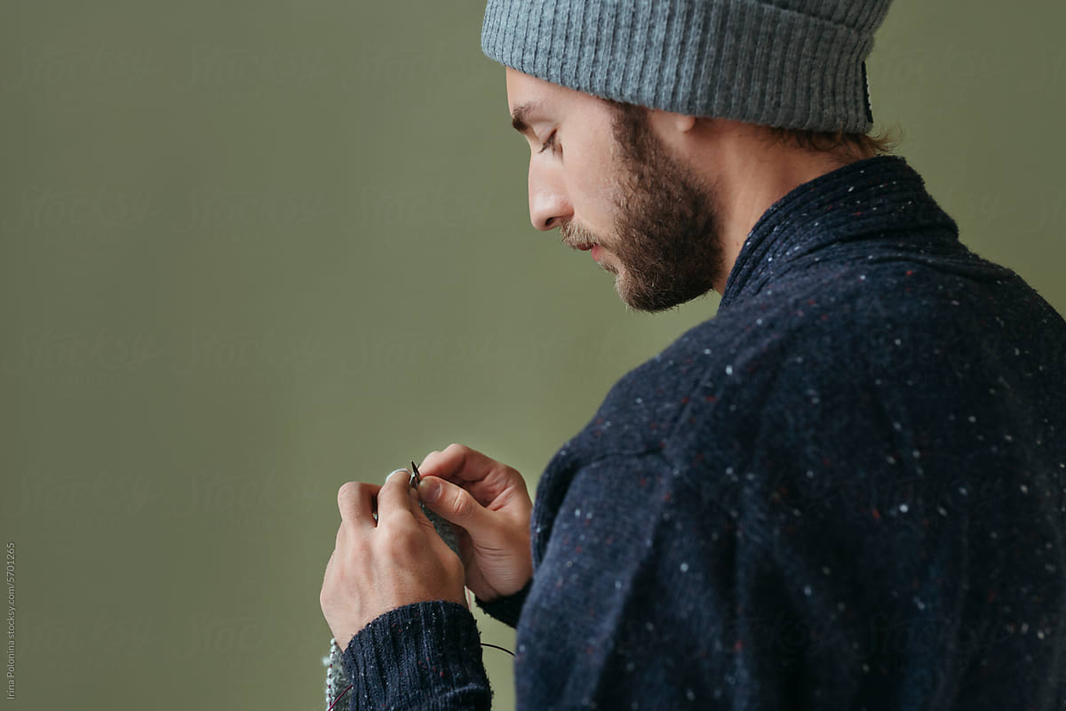 Knitting modern man on green background.