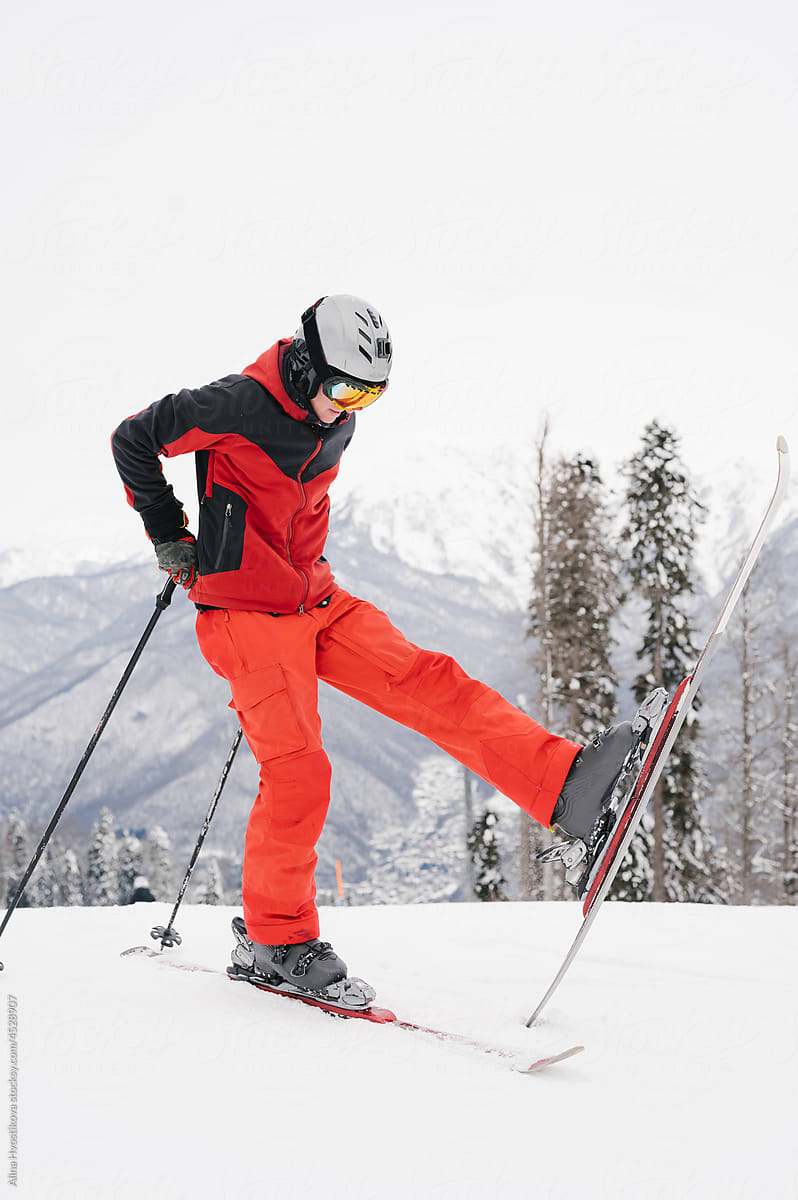 Skier balancing on snowy slope